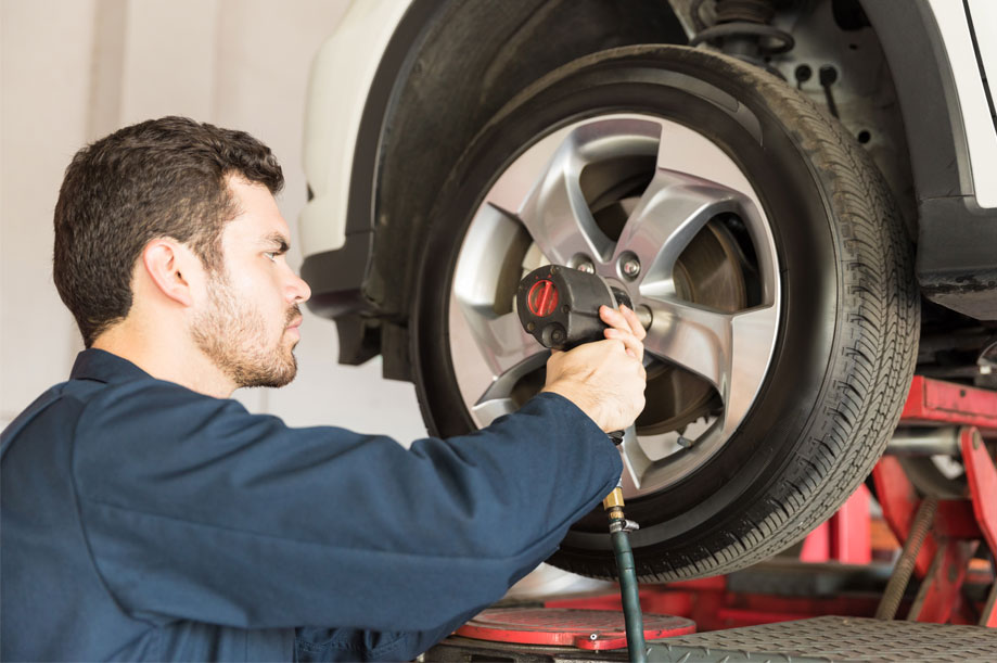 Myers Tires Supply installing a new tire back on a car with a impact air gun