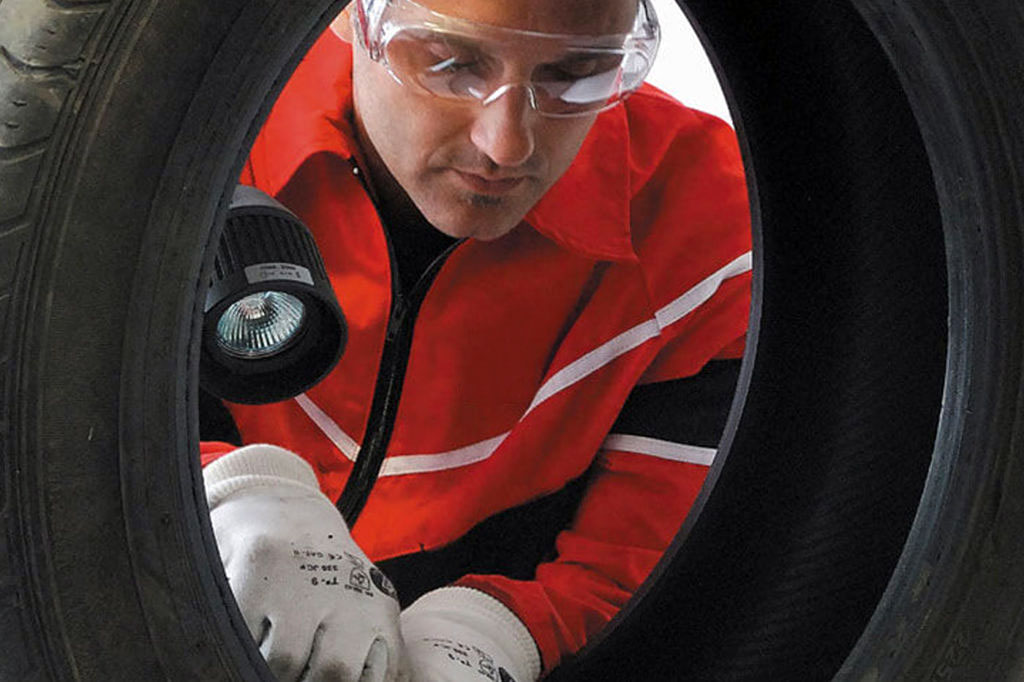 Myers Tire Supply inspecting tire